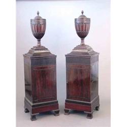 A good pair of Edwardian mahogany urn shape knife boxes, with pineapple finials and rising tops,...