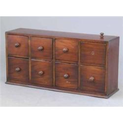 A mahogany bank of eight small drawers, fitted knob handles, 2ft 10ins...