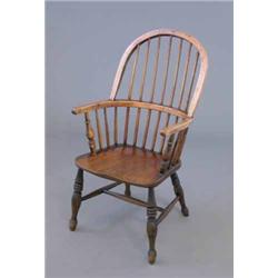 A 19th century ash and elm hoop back Windsor chair, on turned baluster legs...