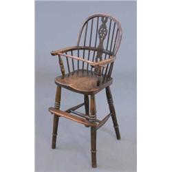 An early 20th century oak and beech wheel back high chair....