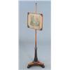 Image 1 : A Regency rosewood pole screen with embroidered panel on spiral fluted column and triform base...
