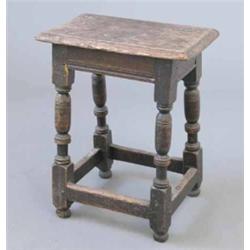 A 17th century oak joynt stool, on ring turned legs with uniting stretchers, 1ft 7ins...