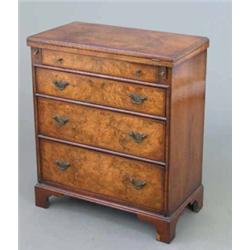 A reproduction walnut bachelors chest, of drawers on bracket feet, 1ft 11ins...