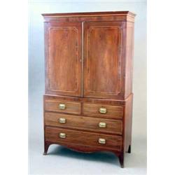 An early 19th century mahogany linen press, with inlaid and crossbanded decoration, two doors enc...