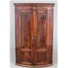 Image 1 : A George III inlaid mahogany bowfront hanging corner cupboard, with two panelled doors enclosing...