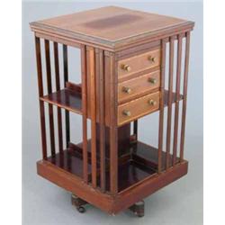 An Edwardian inlaid mahogany revolving bookcase, with three small drawers, 1ft 8ins...