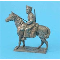 A plated model of a Hussar on horseback, on ebonised plinth, 8.75 ins....