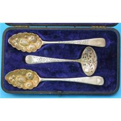 A cased pair of George III silver berry spoons, together with a Hester Bateman sifter ladle...