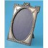 Image 1 : An Edwardian silver photograph frame, of rectangular form with trophy crest and oval aperture, Bi...