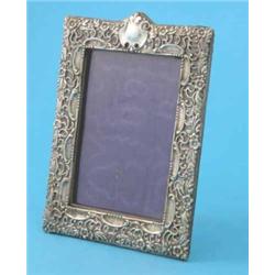 An Edwardian silver photo frame, with pierced flower and scroll decoration, Birmingham 1902, 8ins...