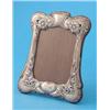 Image 1 : An Edwardian Art Nouveau silver photo frame, of serpentine rectangular form, decorated with flowe...