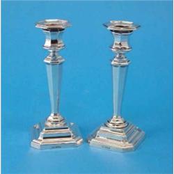 A pair of George V silver candlesticks, of tapered octagonal form, with loaded bases, Sheffield 1...