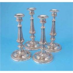 A set of 4 Elkington & Co plated candlesticks, with beaded and fluted columns and circular feet,...
