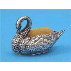 An Edwardian novelty silver swan pin cushion, 2 ins....