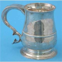 A George II silver baluster mug with scroll handle, Makers initials H.B, 1749, 17 oz....