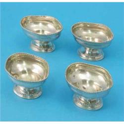 Two pairs of George III silver pedestal salts of beaded oval form, Makers J.S, 1772 and A.P, 1811...