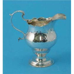 A George III silver helmet cream jug 1790....