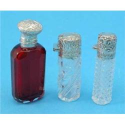 Three Victorian silver mounted glass scent bottles....