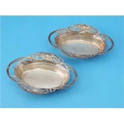 A pair of Art Nouveau silver oval dishes of pierced oval form with stylised foliate decoration, 1...