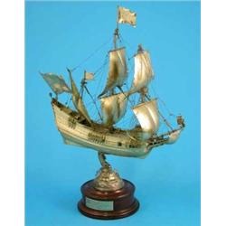 A Dutch gilt white metal model of “De Halve Naen” the first Dutch ship to sail to America, on woo...