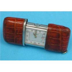 A small Movado travelling watch , self-winding, with crocodile case and date aperture....