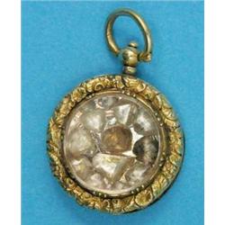 A Victorian gold circular locket, with engine turned and foliate chased decoration containing 11...