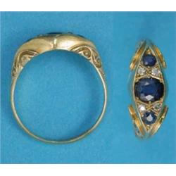A gold 3-stone sapphire ring, the stones spaced by pairs of small diamonds...