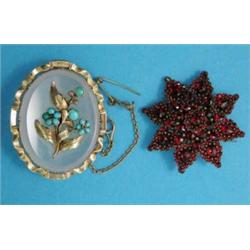 A Victorian garnet set star shape brooch, together with a gold framed chalcedony brooch, the fron...