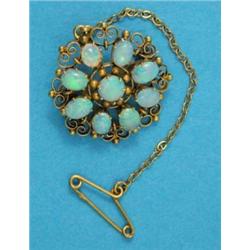 A 9ct gold openwork circular brooch, set 9 opals...