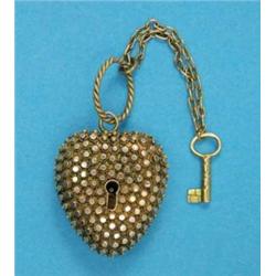A late 19th century gold heart shape locket, with studded decoration and attached key for the cen...
