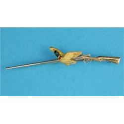 A 9ct 3-colour gold and enamel bar brooch, designed as a shotgun and a mallard duck...