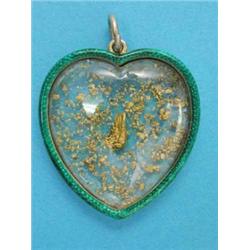 A gold and green enamel heart shape double sided pendant, containing gold nuggets...