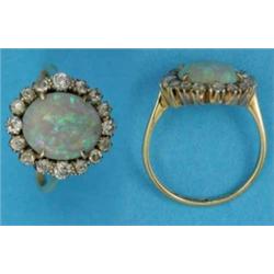 A gold opal and diamond oval cluster ring...