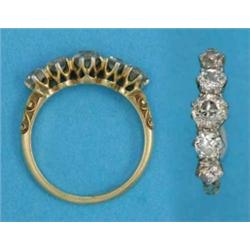 An 18ct gold 5-stone diamond half hoop ring, the centre stone approximately .4ct....