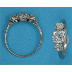An 18ct white gold 3-stone diamond ring, the central cushion shape old brilliant cut stone, appro...