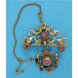 An Eastern gold openwork pendant/brooch, set rubies and diamonds...