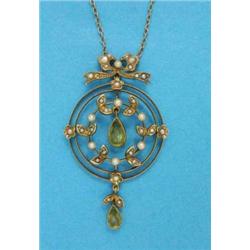 An Edwardian 15ct gold circular openwork pendant, with tied ribbon surmount set seed pearls and p...