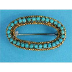 A gilt metal open oval brooch, set turquoises, stamped 750 (converted from a buckle)...