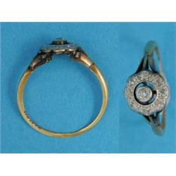 A gold and diamond circular cluster ring...