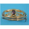 Image 1 : A Victorian gold openwork hinged bangle, the front set with an oval garnet and seed pearls...