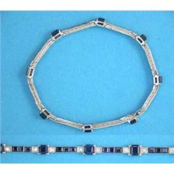 A platinum, sapphire and diamond line bracelet, claw-set with 8 square-cut sapphires, each flanke...