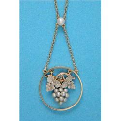 An Edwardian 2-colour gold and seed pearl pendant, designed as an open circle, the centre with an...