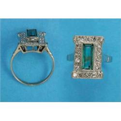An 18ct white gold synthetic emerald and diamond rectangular cluster ring, the collet set slender...