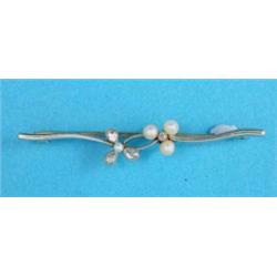 An Edwardian gold and platinum double shamrock bar brooch, set pearls and pear shape diamonds...