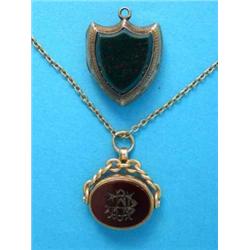 An 18ct gold mounted hardstone swivel fob seal, on gold tracelink chain, together with a shield s...