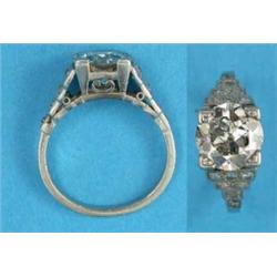 A platinum solitaire diamond ring, the old brilliant cut stone flanked by diamond set stepped sho...