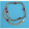 Image 1 : A gold rectangular link necklace, set 6 cabochon oval rubies, each flanked by 4 small diamonds 14...