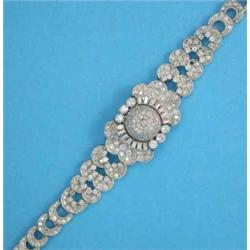 A lady’s all diamond cocktail watch, pave-set with baguette and brilliant cut diamonds, the centr...