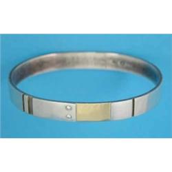 A Georg Jensen silver and gold stiff bangle, set 2 diamonds, No.334...
