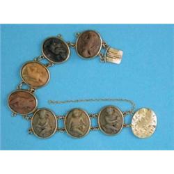 A Victorian gold mounted lava cameo bracelet, the 7 oval cameos carved putti...
